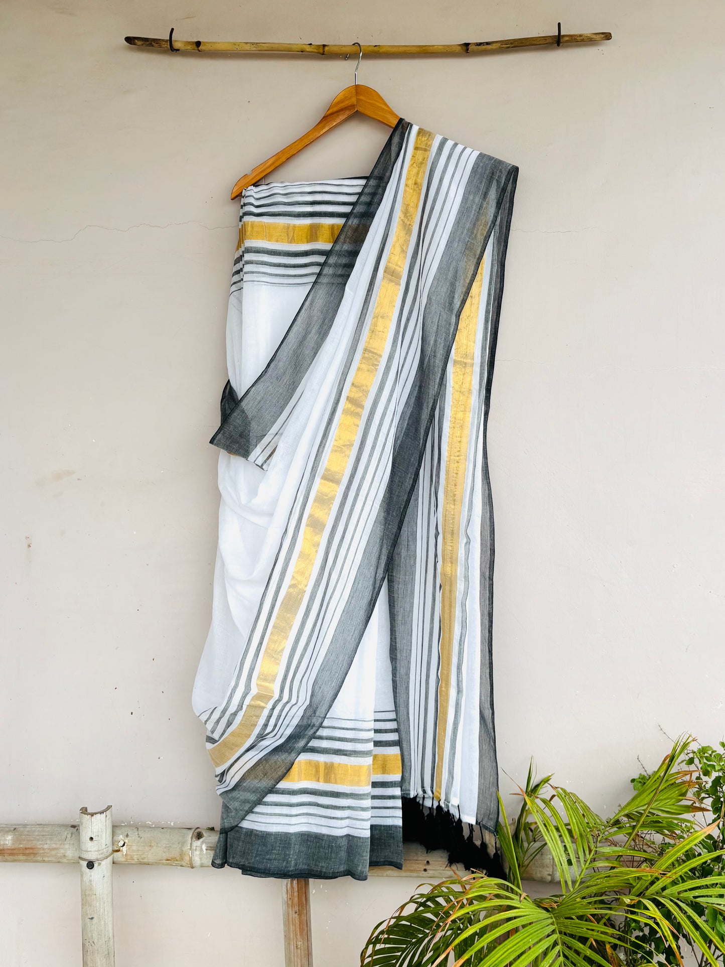 White Mul saree with grey-golden borders.